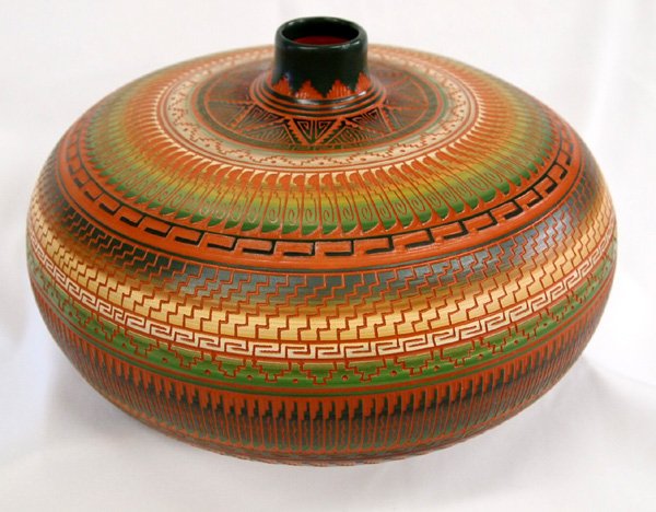 Navajo Incised Pot by Terry Smith: Navajo Incised Pot by Terry Smith, number 209582, stylized feathers and geometric designs. Warm earth tone colors. Pulled spout. Signed on bottom. Shiprock, NM. Measures 12 3/4'' x 6 1/2 diam.