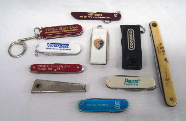 10 Advertisement Pocket Knives: Collection of 10 Varied Pocket Knives. Longest is 4.5''. One from Mesa Verde, some salesman advertisements and some have keychain links.