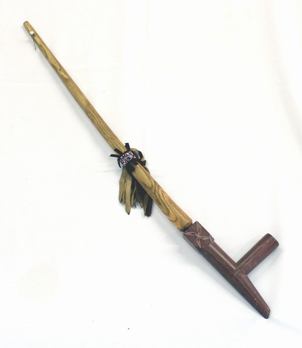 Plains Indian Catlinite Pipe with Wooden Stem: Plains Indian Calinite Pipe and Wooden Stem. Pipe with carved designs. Wooden stem has decorative beads wrapped around leather fringe. Measures 28''L total length. The soapstone pipe is 7.5''x3.5''.