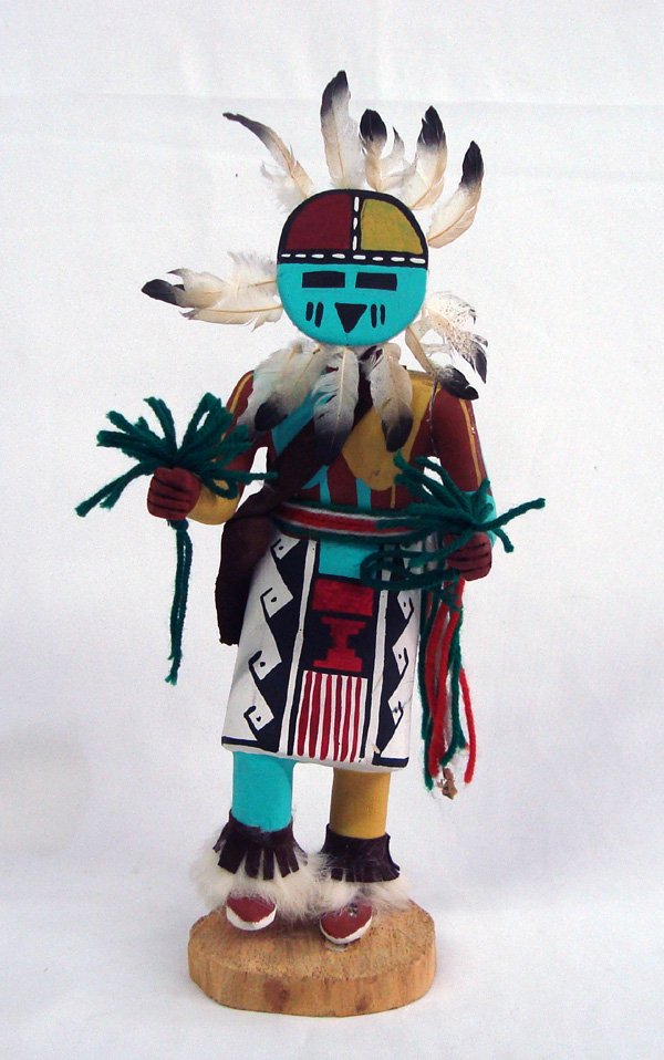 Hopi Sun Kachina by Roger Singer: Hopi Sun Kachina by Roger Singer. 14''H x 6''W. This Sun Kachina is also known as Tawa or the Sun Shield kachina & is a representation of the spirit of the sun. The sun kachina has an important part i