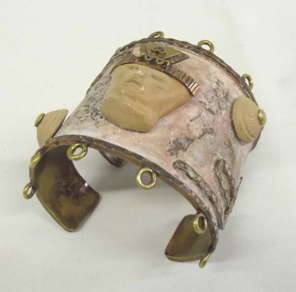 Mexican Mayan Motif Brass Cuff Bracelet: Mexican Mayan Motif Brass Cuff Bracelet. Striking workmanship in this wide cuff bracelet with Mayan figures worked in relief. It measures 7 1/4'' x 2 1/2'' wide.
