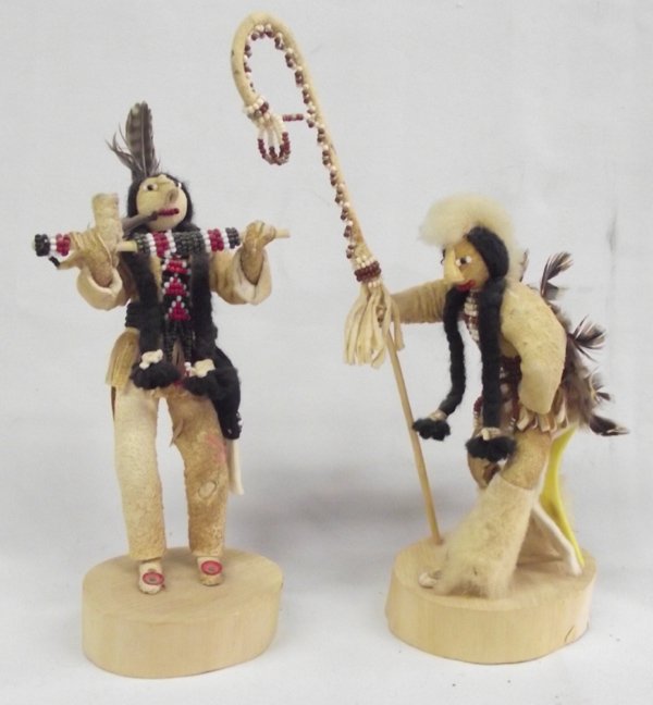 Shoshone Beaded Dolls by Cecilia & Dianne Ottogary: Native American Shoshone Beaded Dolls by Cecilia & Dianne Ottogary, smoked and beaded hide, both are signed on bottom of wood bases, #1 by Cecilia Ottogary has black braided hair, is holding a beaded