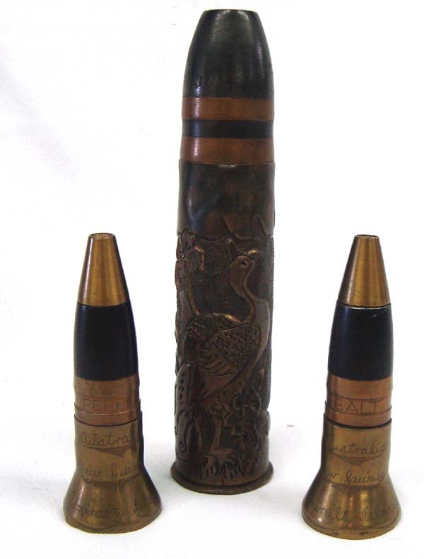 Vintage 1940s Trench Art Shell Casings: Vintage 1940s Trench Art Shell Casings, to include three large shell casings. The largest has a repousse scene of a stork, measures approx.7.5''L.