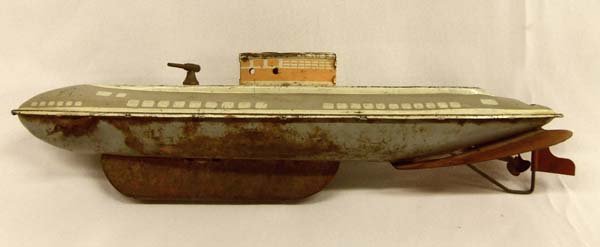 Antique Wolverine Tin Submarine Toy: Antique Tin Submarine Toy, measures approx.13''L x 3'' W. No key, some rust on bottom. Propeller turns and gun turns.