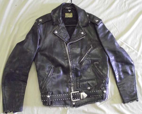 Northeaster Flying Togs Beck Black Leather Jacket: Northeaster Flying Togs Beck Black Leather Jacket, metal stars and studs on shoulderstraps, zippered sleeves and pockets, leather studded belt around waist held there with leather belt loops, 1 snap p