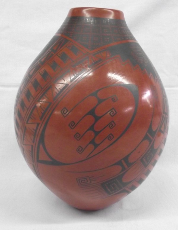 Mata Ortiz Black on Red Pottery Jar - Cesar Bugarini: Mata Ortiz Traditional Black on Red Pottery Jar by artist Cesar Bugarini. Tall, oval jar with geometric black designs on reddish brown background by Cesar Bugarini. Measures 10.5''H x 8.5''W.