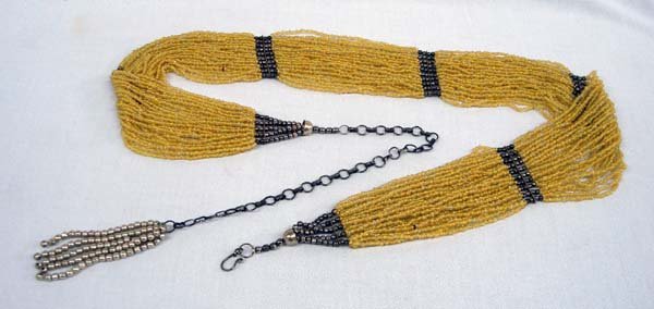 30 Strand Seed Bead Beaded Belt: Seed Bead and Metal Balls Beaded Belt. Go for a vintage or new look with this beaded belt as your accessory. There are 30 strands of yellow seed beads gathere in groups of six at the ends of the belt 