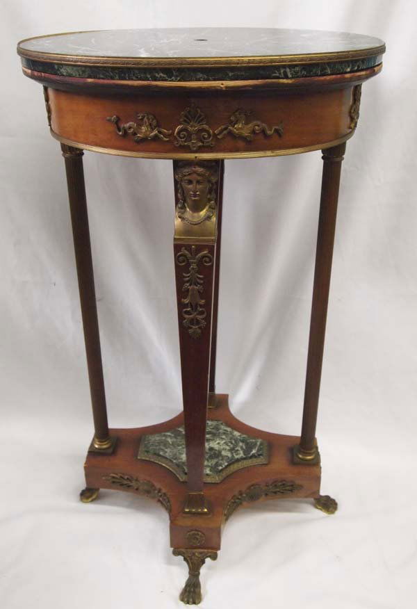 Antique Whelan Estate Marble Walnut Brass Lamp Table: Vintage Marble, Maple and Brass Oval Lamp Table. This ornately embellished table has a green marble top and piece on the bottom wooden support shelf. A small hole is drilled for a lamp cord on the top