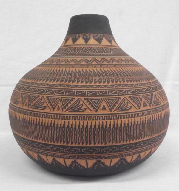 Navajo Large Sgrafitto Pottery Jar - Terry Smith: Native American Navajo Large Sgrafitto Pottery Jar - Terry Smith. Intricate feather and other symbolic designs surround this beautiful Navajo pottery jar. The designs are dark brown and the base color
