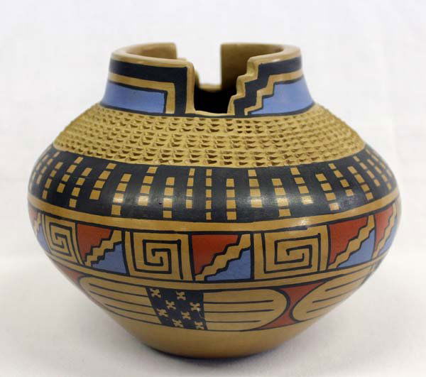 Mata Ortiz Polychrome Vase - Jesus Tena: Mata Ortiz Polychrome Vase - Jesus Tena with Stairstep Cutouts on either side. The Greek Key and water designs the widest part of the vase. Near the top is textured. Red, black, blue on beige backgrou