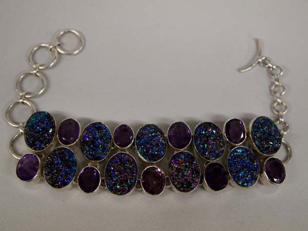 Titanium Peacock and Amethyst Druzy Bracelet: Titanium Peacock and Amethyst Druzy Bracelet. Set on sterling, this adjustable bracelet is 8.25''L x 1-1/8''W. It has a toggle clasp and is truly gorgeous!