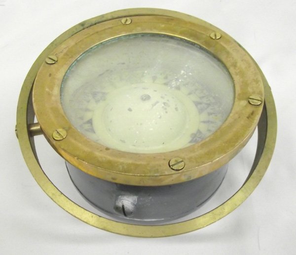 Antique Brass Ship Compass: Antique Brass Ship Compass. Has a mounting hole on the bottom and possible mounting holes on brass ring around the main body. Some cloudiness inside the glass. Nice patina on the top rim. 6.25'' diame