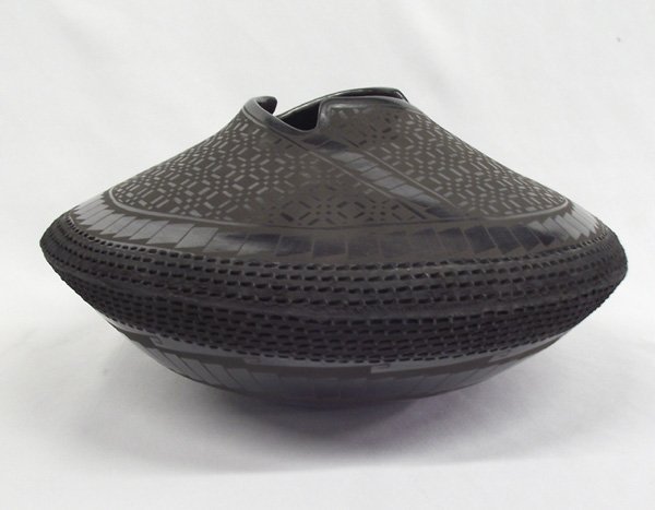 Mata Ortiz Textured Black Bowl Benjamin Soto: Mata Ortiz Textured Black Bowl Benjamin Soto. This wide, shallow bowl has fine geometric designs as well as textured strips around the midline and a cutaway rim. It is signed on the bottom, ''Benjamin