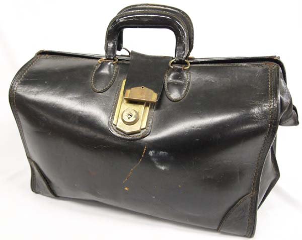Antique Leather Valise by C H Ellis Company: Antique Leather Valise by C H Ellis Company. This wonderful old leather valise has a brass locking system (key is missing) and 8 brass rounded feet on the bottom. It has two leather handles. On the bo