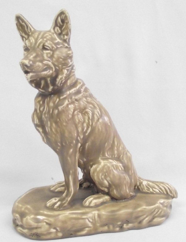 Vintage Weller Art Pottery German Shepherd Dog: Weller Dog Statue. Glazed ceramic German Shepard dog with a loving look. His muzzle has been broken off and glued back on, from right under the eyes and around the jaw. He measures 9''H x 8.5''W.