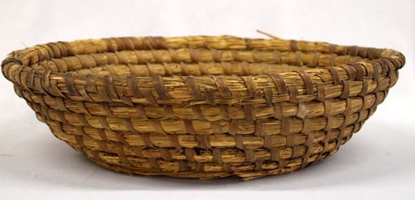 Pima Wheat Straw Handwoven Basket: Pima Wheat Straw Handwoven Basket. The Pima Indians, Akimel O'odham, are known for their fine Indian baskets. 4.25''H x 16'' diameter. Bottom has residue and the rim has normal wear from use. Item fou