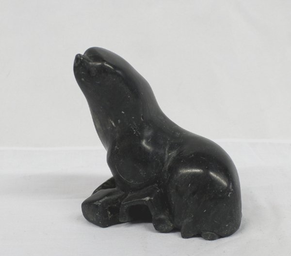 Eskimo Inuit Carved Soapstone Seal by Peter Huit: Eskimo Inuit Carved Soapstone Seal by Peter Huit, measures approx. 5'' x 4'' x 3''. Seal is marked on the bottom by artist Peter Huit. Nose on seal has slight rubbed area.