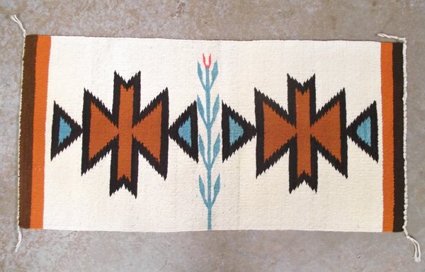 Navajo Textile: Navajo Textile. 36''L x 18.5'' W. Butterfly and corn stalk. Light stain on one side. Navajo textiles were originally utilitarian blankets for use as cloaks, dresses, saddle blankets, and similar purpo