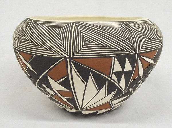 Acoma Pueblo Polychrome Jar - L. Skazzie: Acoma Pueblo Polychrome Jar - L. Sakazie. 5''H x 7'' diameter. Signed on bottom by the artist. Acoma Pueblo is situated on top of a mesa, hundreds of feet above the surrounding land in New Mexico. It 