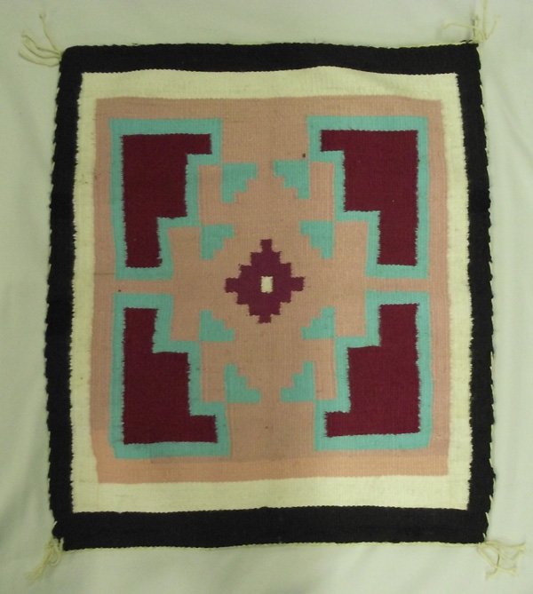 Navajo Teec Nos Pos Rug - George Pemington: Navajo Teec Nos Pos Weaving Rug - George Pemington. This textile measures 21'' x 25''. Lovely colors of mauve, maroon, turquoise, white and black. Edging complete and tassels in good condition. Teec N