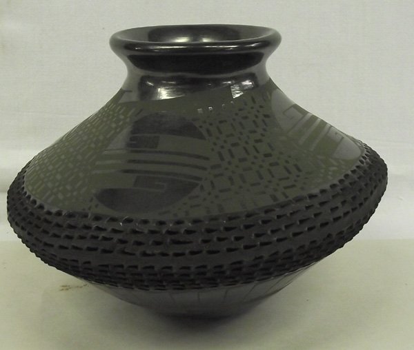 Mata Ortiz Green on Black Jar - Benjamin Soto: Mata Ortiz Green on Black Jar - Benjamin Soto. There is a wide band of green on black geometric designs around the top of this jar and textured flat black design around the middle. Around the bottom, 