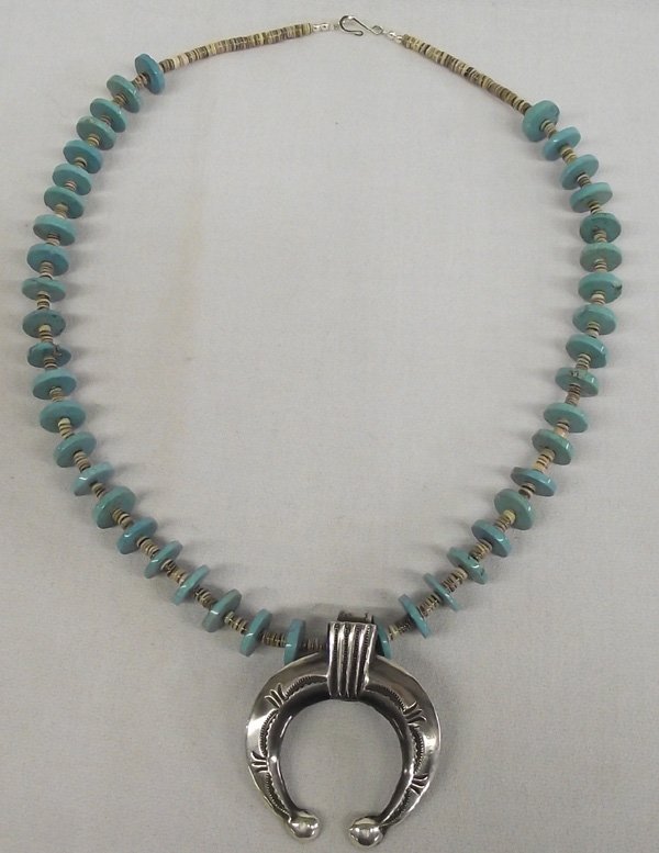 Navajo Sterling Turquoise Naja Necklace - Mitchell: Navajo Turquoise Disk and Heishi Shell Necklace with Sterling Naja- E.S. Mitchell. Nice sandcast sterling silver pendant in the shape of a Spanish naja. Created by Navajo silversmith, Eugene S Mitchel