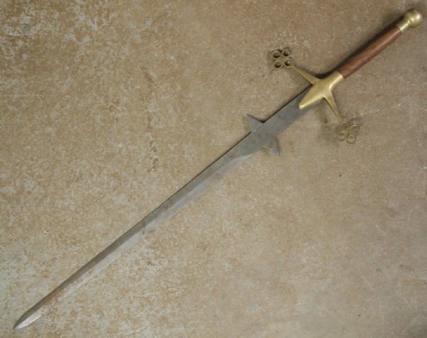 Excaliber Two Hand Sword: Very Large Two Hand Sword. A sleek and beautiful sword with a wood and brass handle and stainless steel blade. It measures 56''L x 13-5/8''W and weighs 6 pounds.