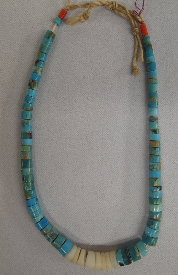 Navajo Turquoise Bead Jocla: Navajo Turquoise Bead Jocla. Graduated turquoise disc beads and center white disc beads, and a small coral bead on each end of this string jocla. It measures 13'' around.