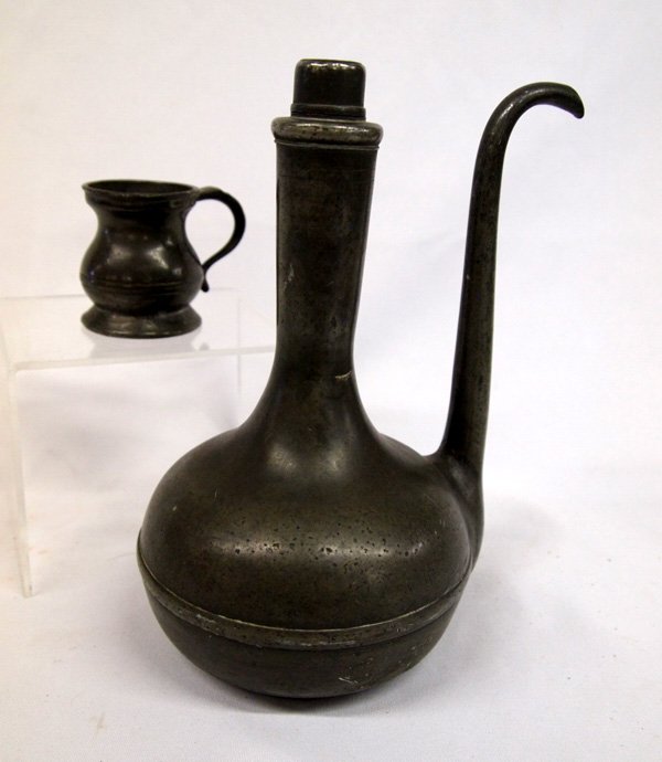 Antique Pewter Pitcher and Small Mug: Antique Pewter Pitcher and Small Mug. A narrow spout and no handle, there are no identifying markings that I can find. 8''H x 7'' diameter. The small mug is stamped under the lip and has a symbol next