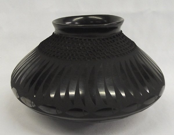 Mata Ortiz Black Textured Jar - Jose Gonzalez: Mata Ortiz Black Textured Jar - Jose Gonzalez. Nicely shaped jar with texture at the neck and fish-like designs around the midline. Signed on the bottom, Jose Gonzalez. Measures 5''H x 9''W. Mata Orti