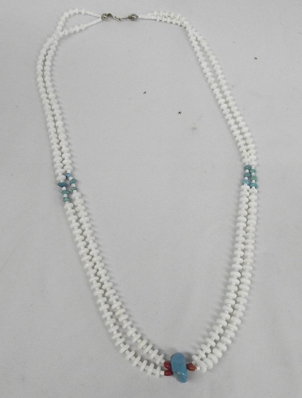 Santo Domingo Two Strand Necklace: Santo Domingo Two Strand Necklace. Bottom center binds both strands of white beads with a .75'' x 5/8'' turquoise nugget and coral beads. 28''L. Stunning!
