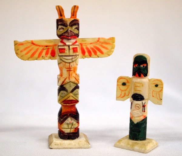 Two Mini Bone Carved, Handpainted Totem Poles: Two Mini Bone Carved, Handpainted Totem Poles. Smaller is removable from the base. Tallest measures 3.25''H x 2.25''W. Totem poles are typically carved from the trunks of western red cedar trees and r