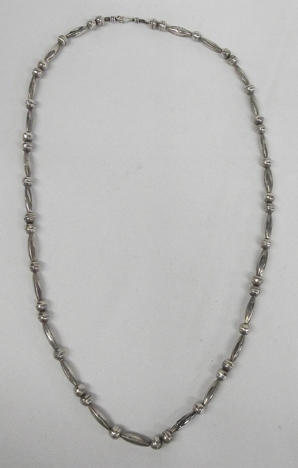 Navajo Handmade Silver Mellon Bead Necklace: Navajo Handmade Silver Mellon Bead Necklace. This necklace has melon beads that are alternately separated with one or two sterling silver balls. The melon beads are 3/4'' long. Overall, the necklace i