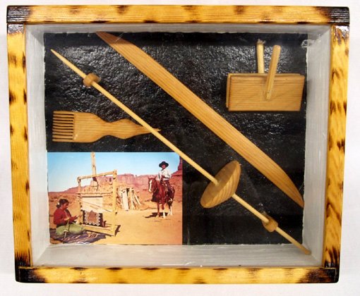 Wood Diorama Box Navajo Weaver's Tools: Wood Diorama Box Navajo Weaver's Tools. This box contains mini versions of the weaver's tools and a photo of a Navajo weaving at her outdoor loom. The outside dimensions of the glass top box are 10'' 