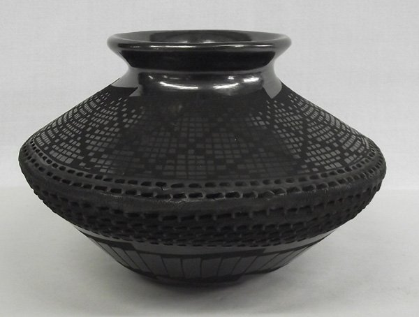 Mata Ortiz Black Eye Dazzler Bowl - Benjamin Soto: Mata Ortiz Black Eye Dazzler Bowl - Benjamin Soto. This lovely eliptical bowl has squares and diamond eye dazzler patterns on the upper half and texture on the midline. The bottom half has feather des