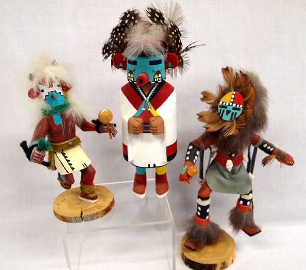 Three Hopi Kachinas-Signed by Artists: Three Hopi Kachinas-Signed by Artists. 1) ''Snow, ML Begay'' 2) '' Wm Sesakaka'' 3) ''Sunface by A. Largo''. Tallest 8''H including feathers x 4.5''W. Much detail on all three.