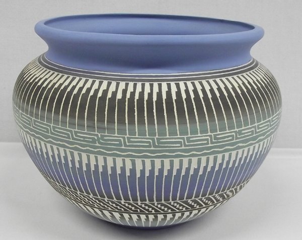 Navajo Sgrafitto Pottery Bowl: Navajo Sgrafitto Pottery Bowl. This lovely bowl has sky blue on the neck and rim, midline and bottom. Prayer feather designs are in three rows with a mixture of turquoise, blue and brown colors. Measu