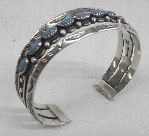 Vintage Fred Harvey Turquoise Sterling Bracelet: Vintage Fred Harvey Era Turquoise Sterling Bracelet, Bell Trading Hallmark. Nine turquoise cabochons beautifully set. Wrist measures 6.25'' x .75''H. The Bell Trading Company was founded in Albuquerqu