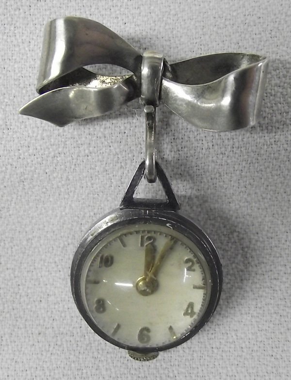 Antique 1900s Booch Pin Watch- Normis Watch Co.: Antique Sterling Booch Pin Swiss Watch -Sterling A & Z stamped on stamped pin bow. 2''L x 1''W Double sided dome. Watch Runs! NORMIS Watch CO. known reputation, from the 1920s, for its sophisticated h