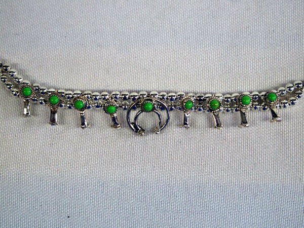 Navajo Turquoise & Silver Squash Blossom Bracelet: Navajo Green Turquoise & Silver Squash Blossom Bracelet, Signed. Petite all sterling silver set with green turquoise. By Navajo artist, Larry Curley. Measures 8'' in length, blossoms measure 3/8'' x 1