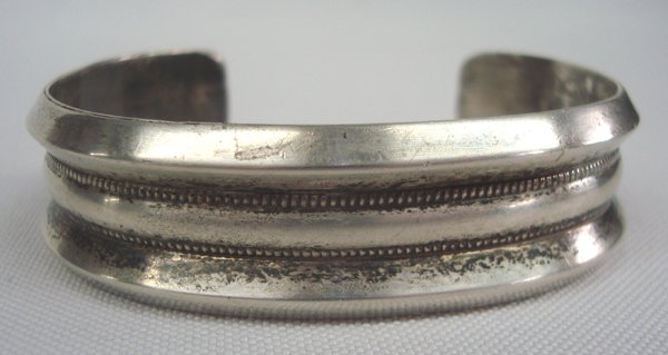 Navajo Old Pawn Sterling Silver Bracelet by Tulley: Navajo Old Pawn Sterling Silver Bracelet by Tulley. Heavy hand-crafted sterling silver bracelet, hallmarked by artist Eddy Tulley. Bracelet appears to be 3 bangles together with tiny rope-twist betwee