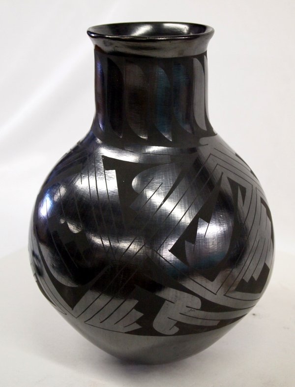 Mata Ortiz Tall Black Jar - Beto Tena: Mata Ortiz Tall Black Jar - Beto Tena. Black on black geometric designs. Signed on bottom by artist, Beto Tena. Measures 12''H x 9''W. Mata Ortiz is a small village in the state of Chihuahua, Mexico. 