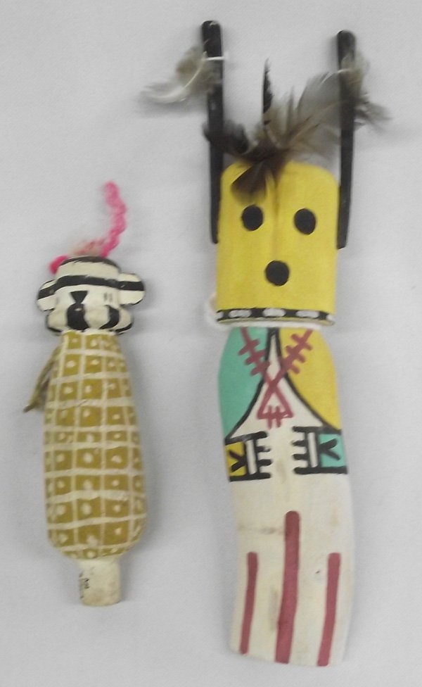 2 Hopi Child's Cradle Kachinas: 2 Hopi Child's Cradle Kachinas. One kachina is a flat back. It has a curved lower body and ''horns''. It measures 7.5''H x 1.75''W and is signed on the back. The other kachina is a corn figure. It has