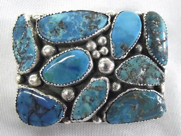 Navajo Sterling Turquoise Belt Buckle -- Tsinnie: Navajo Sterling Kingman Turquoise Belt Buckle -- Orville Tsinnie, measures 2.5'' x 1.75'', features 9 large cabochons accented with various sized silver beadwork, nice weight, stamped on back is ''Tsi