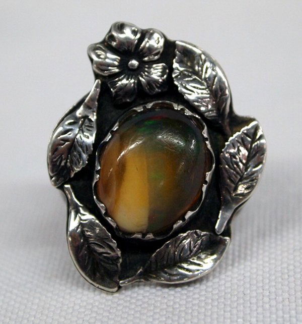 Vintage Navajo Sterling Fire Agate Ring: Vintage Navajo Sterling Fire Agate Ring, unreadable hallmark, size 8.5 and measures 1 1/8''L x 1''W, gorgeous fire opal set in traditional leaf and flower setting, double band shank which tapers down