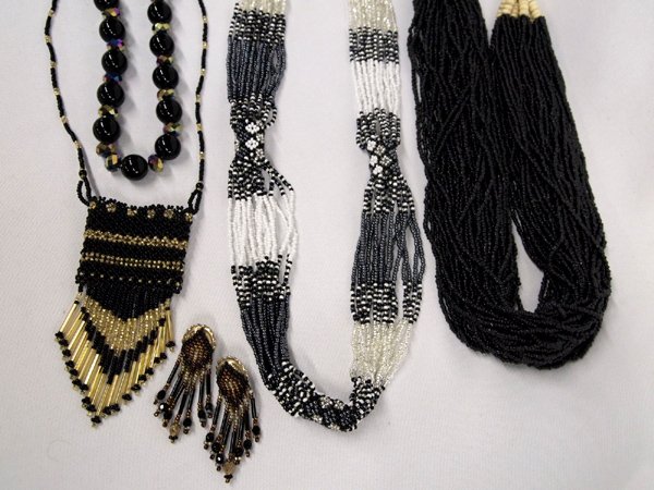 Collection of Beaded Jewelry: Collection of Beaded Jewelry, #1 Multi strand black seed bead necklace with cream colored bead accents and closure, 22'' end to end #2 Black and Gold seed bead pouch necklace, 31'' end to end #3 Auror