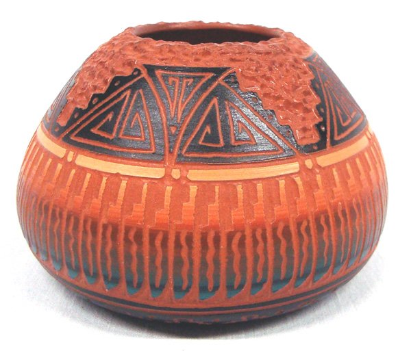 Navajo Carved Pottery Jar - Terry Smith: Navajo Carved Pottery Jar - Terry Smith. A carved and textured deep red color jar with turquoise and black color accents. It is signed on the bottom. Measures 2.25''H x 4''W.