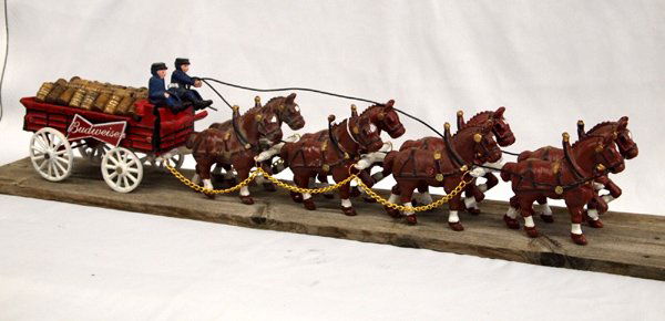 Budweiser Cast Iron Beer Wagon: Budweiser Cast Iron Beer Wagon pulled by 8 Clydesdale Horses, has 2 drivers and 1 Dalmation dog, Budweiser Logos on both sides of wagon, and wooden beer kegs, measures 28''L x 7''H x 4''W