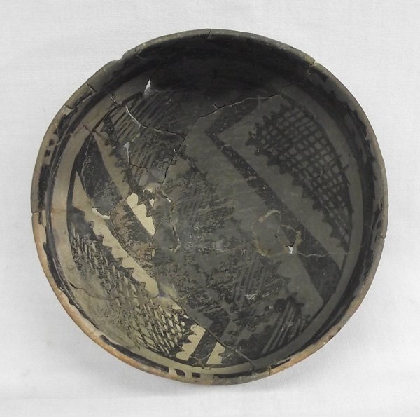 Prehistoric Gila Polychrome Flare Rim Bowl: Prehistoric Gila Polychrome Black, White & Red Flare Rim Bowl, measures 5.5''W x 5.75''H. Fire-clouds. There is a loose tile in the bottom of the bowl. Poorly glued. There is a very unusual 3 & 4 Legg