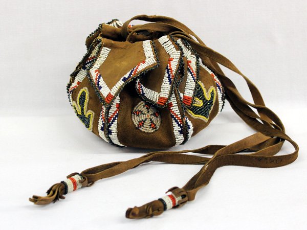 1920 Kiowa/Apache Beaded Hide Bag: 1920 Kiowa/Apache Beaded Hide Bag. Written on the inside of the strap of this sweet little bag is ''May 31 1923 Ethel Samuel Watonga Oklahoma.'' Suede bag measures approx. 4.5''h x 6.5''W.